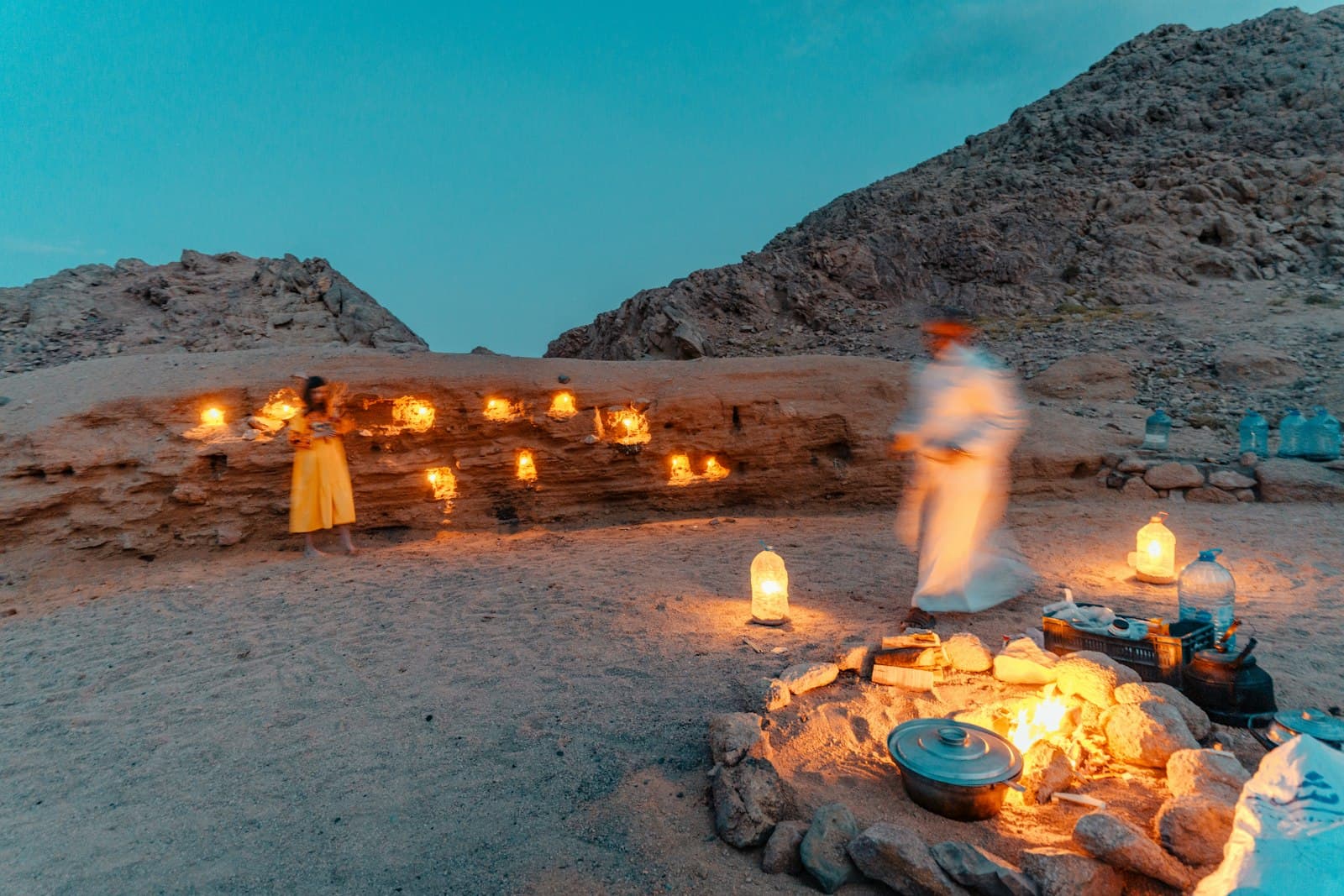Siwa — a group of people around a fire pit with a group of candles