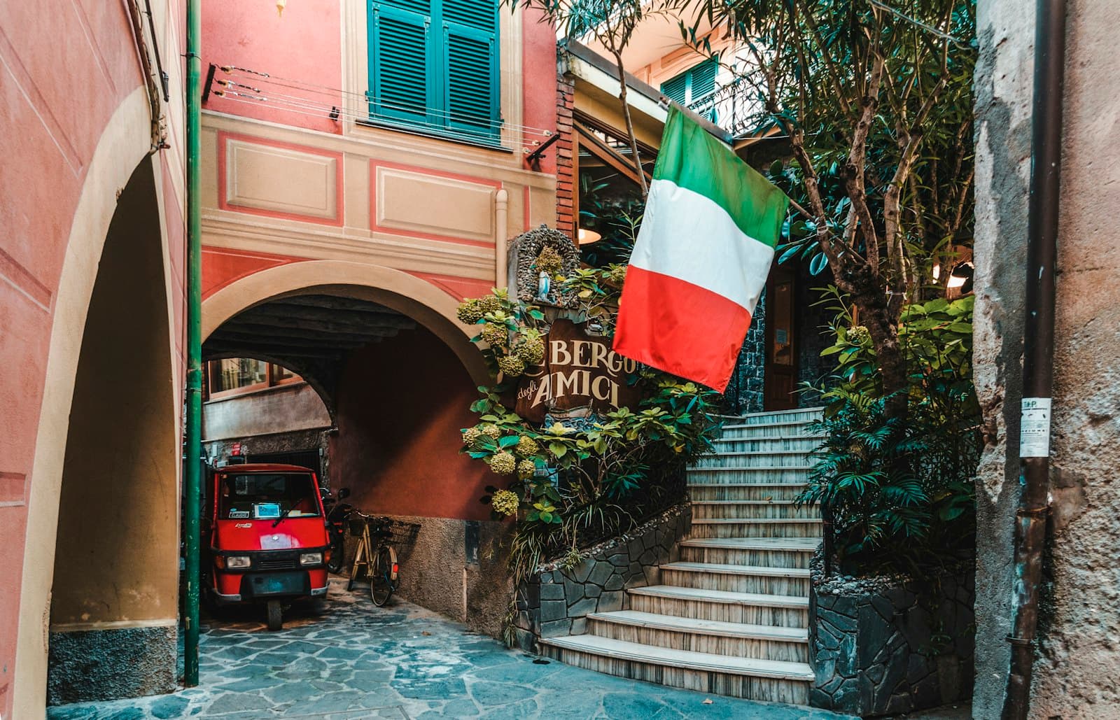 Soave — red auto-rickshaw under arch walkway