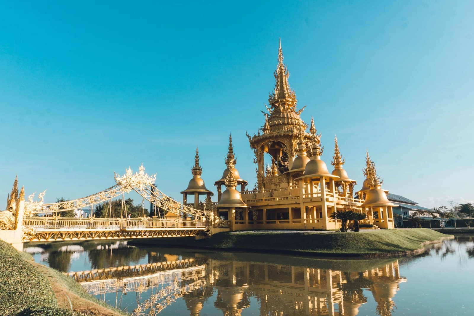 Songkhla — a large golden building sitting on top of a lake