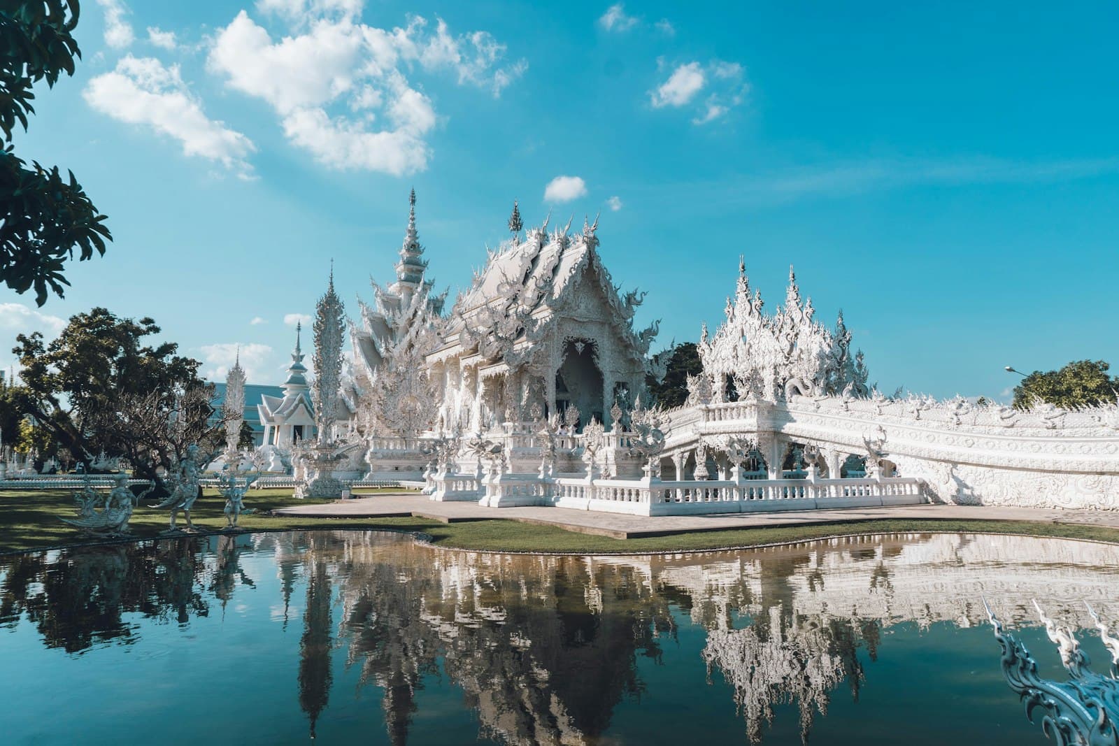 Songkhla — a large white building sitting next to a body of water
