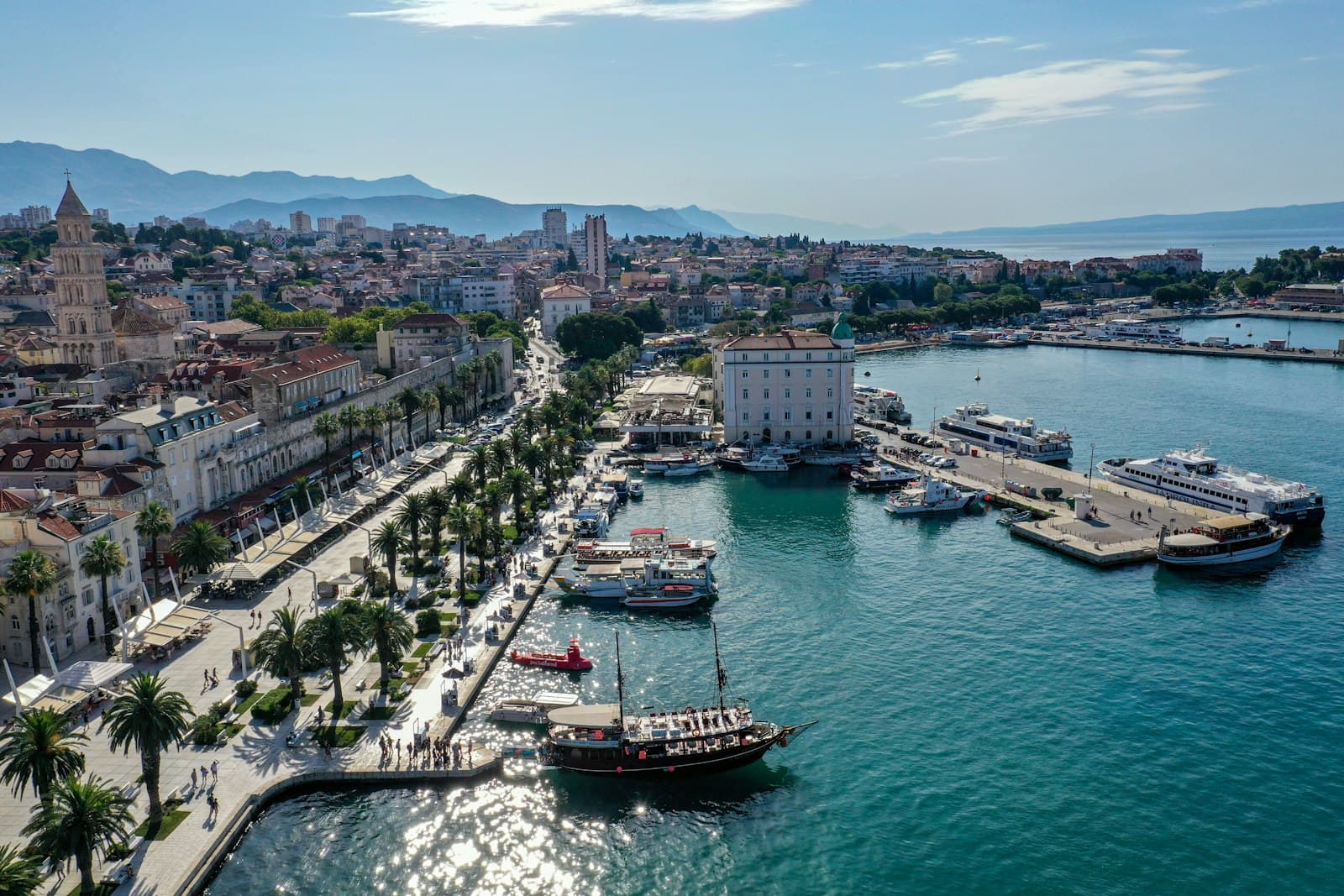 Split — red and white boat on body of water during daytime
