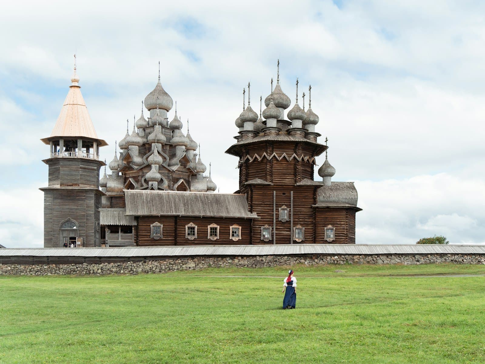 Staraya Ladoga — A person standing in a field in front of a building
