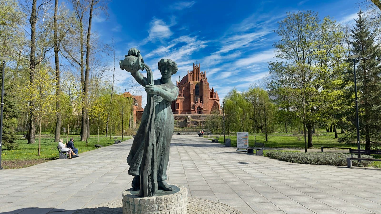 Starogard Gdański — a statue of a woman holding a bird in a park