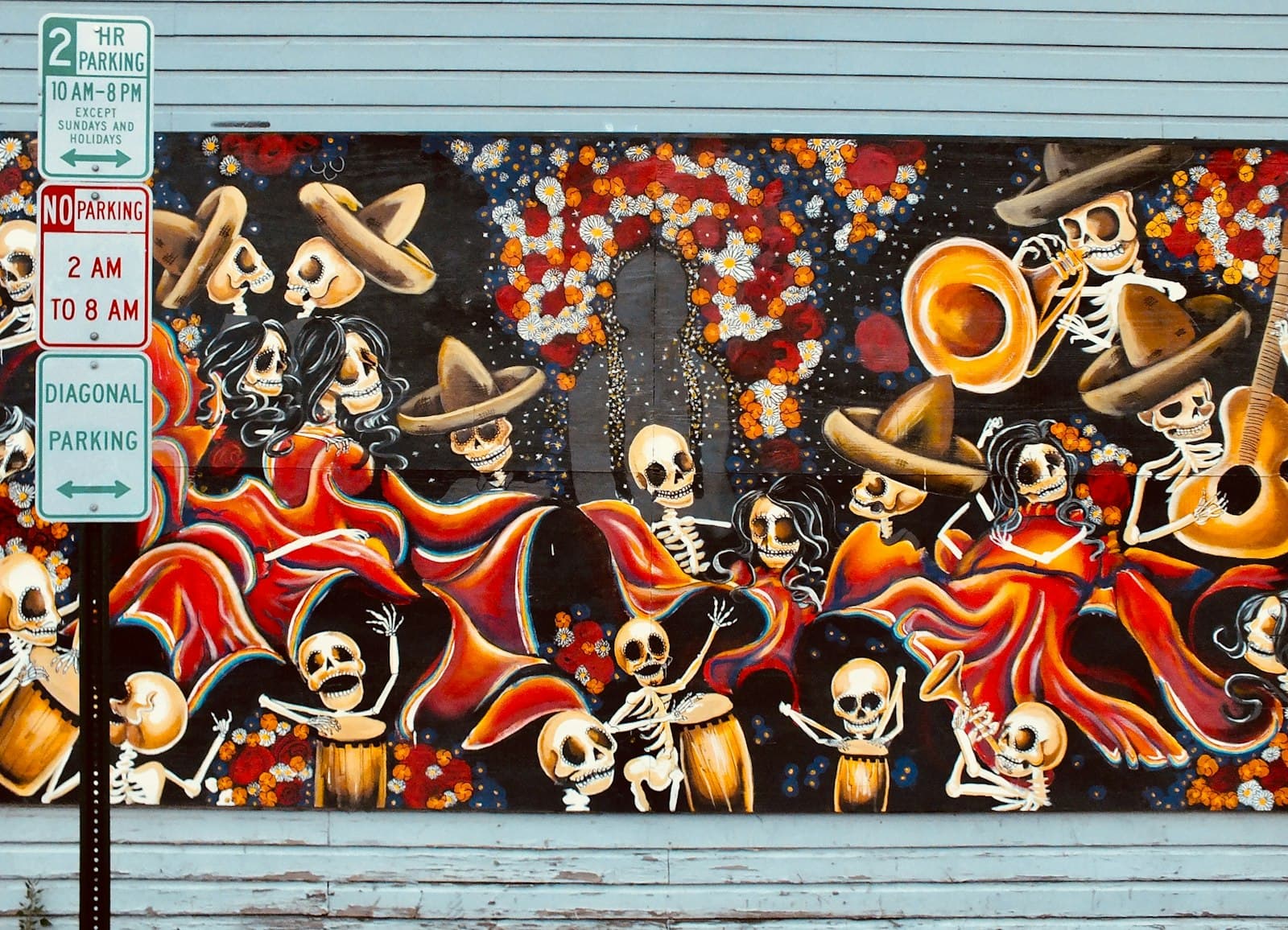 Steamboat Springs — road sign in front of skeleton playing instruments graffiti