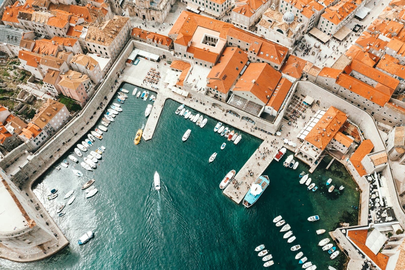 Ston — aerial photography of boats on pier and city