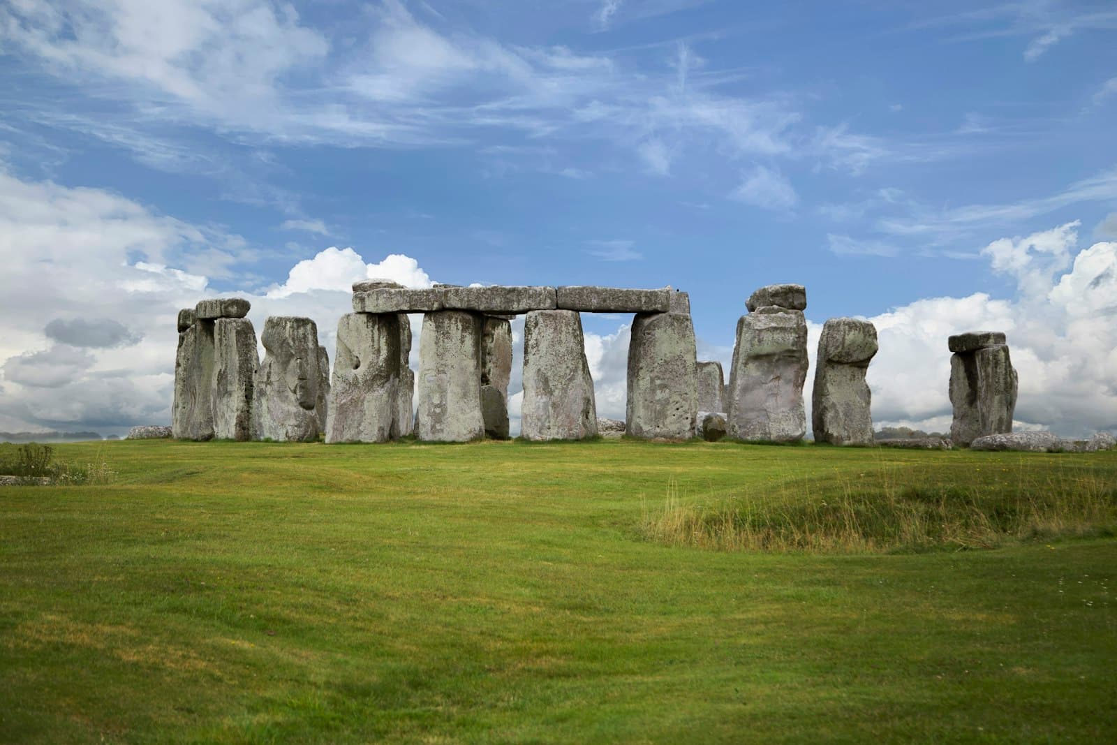 Stonehenge — gray rock formation on green grass field under blue sky during daytime
