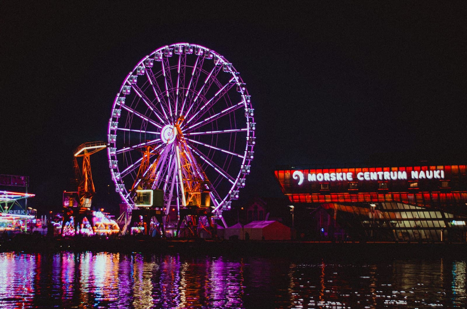 Szczecin — Ferris wheel illuminated at night with reflections