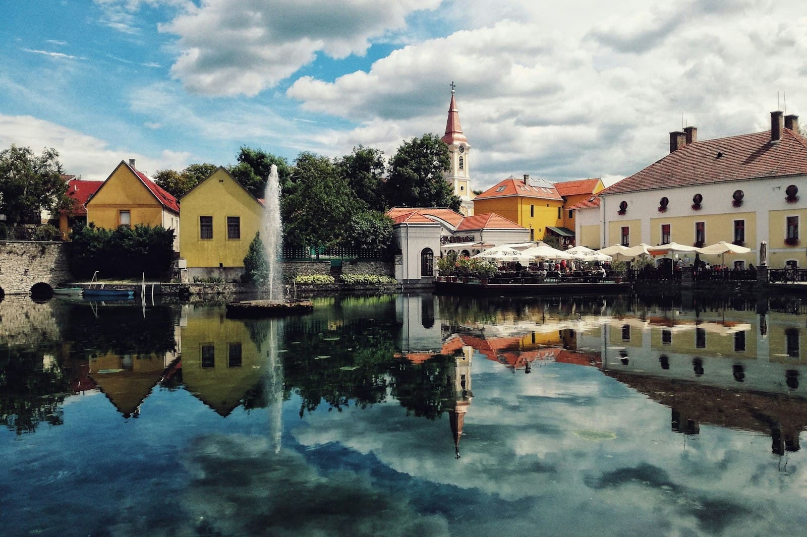 Szentendre — white and brown concrete house beside body of water under blue sky during daytime