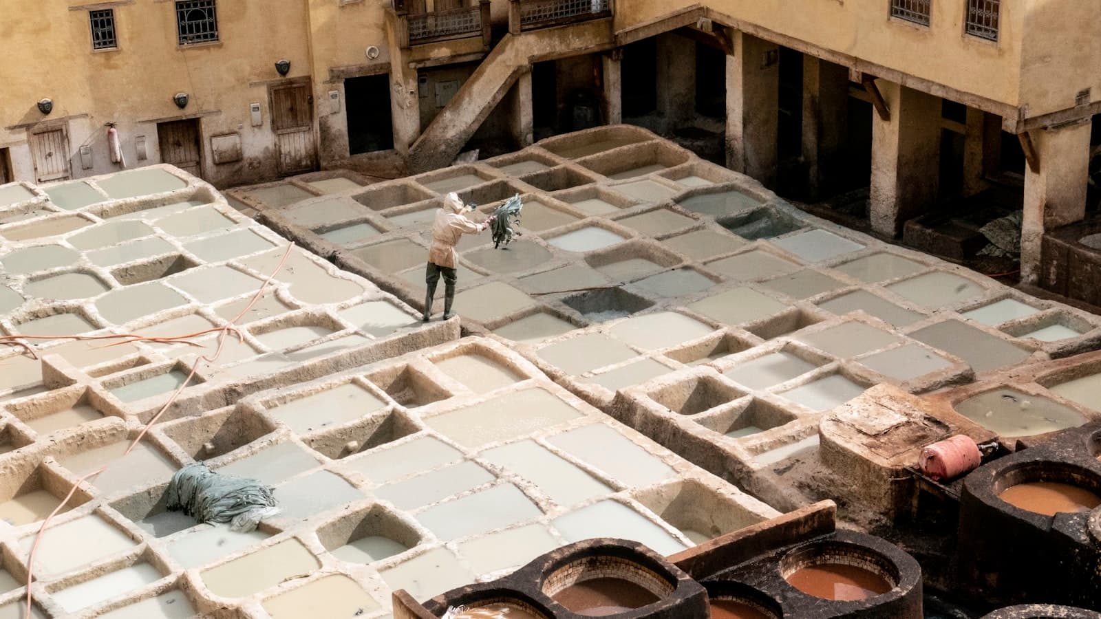 Tan-Tan — person standing grey concrete structure