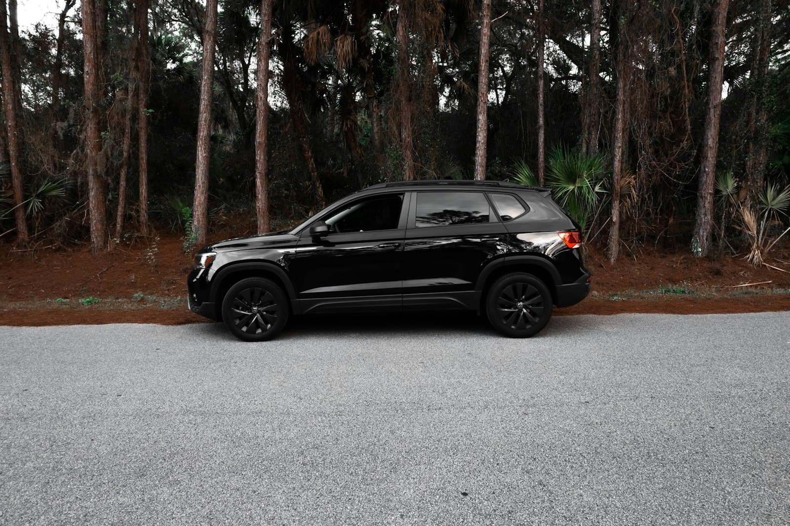Taos — a black jeep is parked in front of some trees