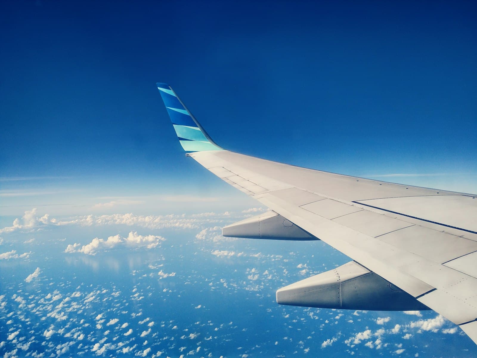 Ternate — white and blue airplane wing during daytime