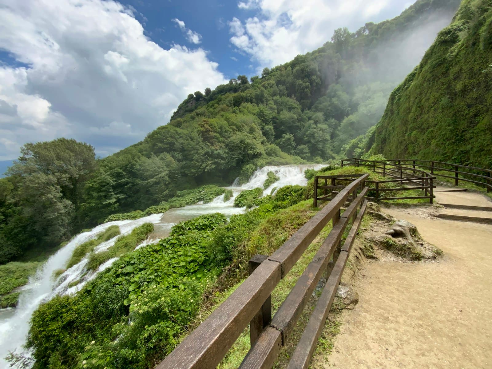 Terni — a wooden fence overlooks a waterfall in the mountains