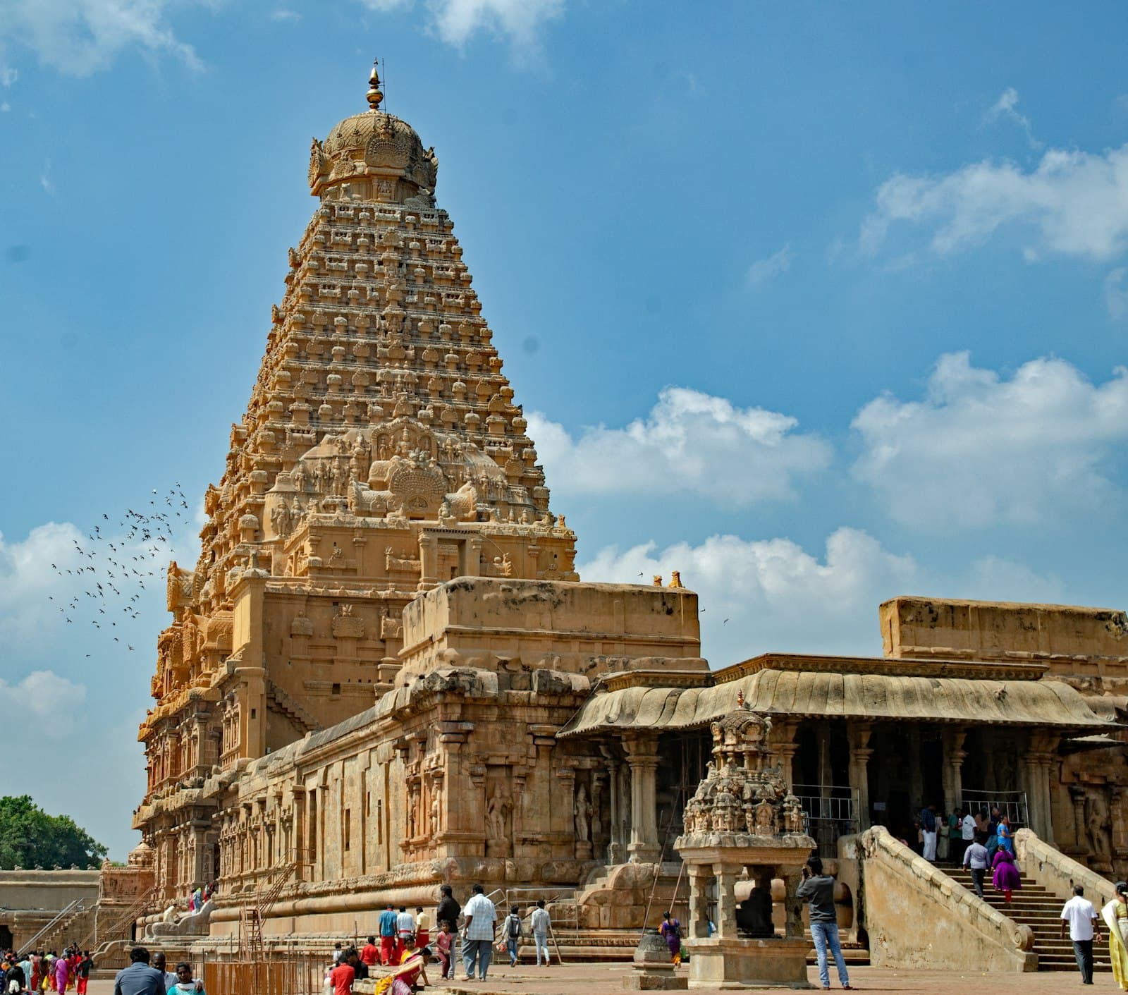 Thanjavur — a group of people standing in front of a tall building