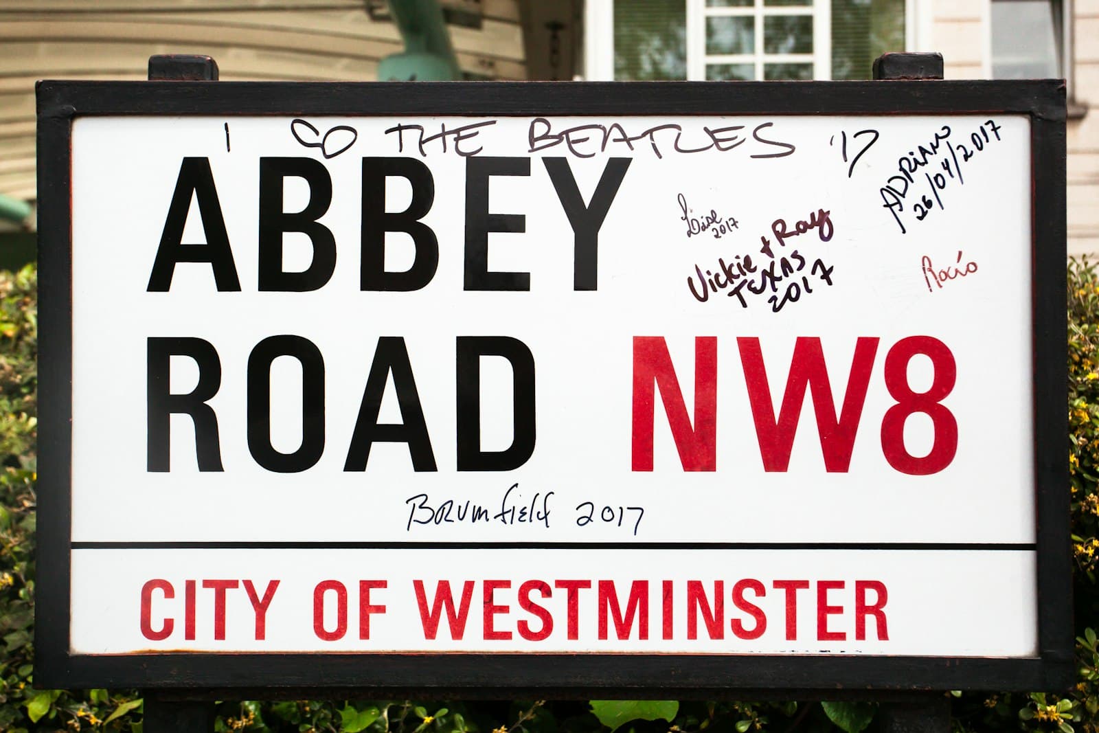 The Beatles in London — Abbey road street sign with graffiti and signatures
