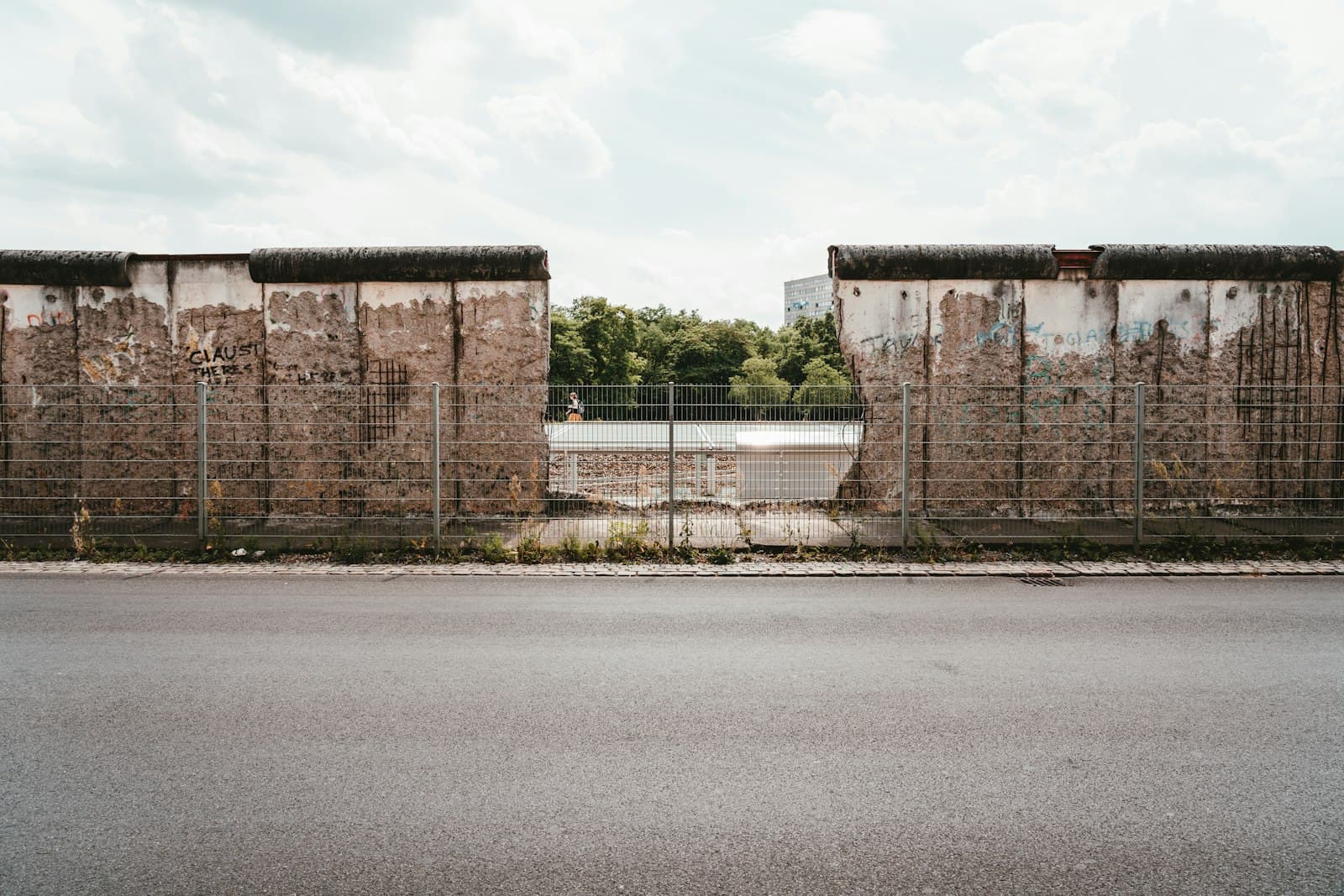 The Berlin Wall & the Cold War — grey metal fence at the other side of the road