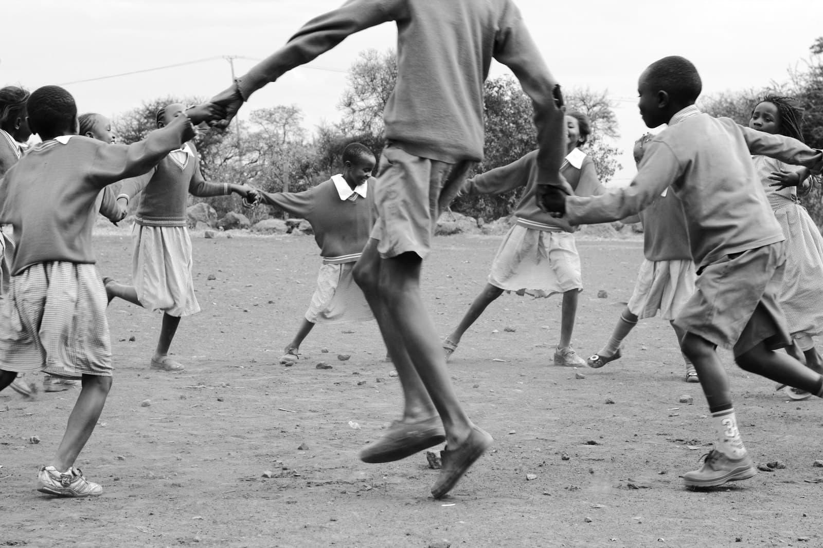 Thika — grayscale photography of people playing outside
