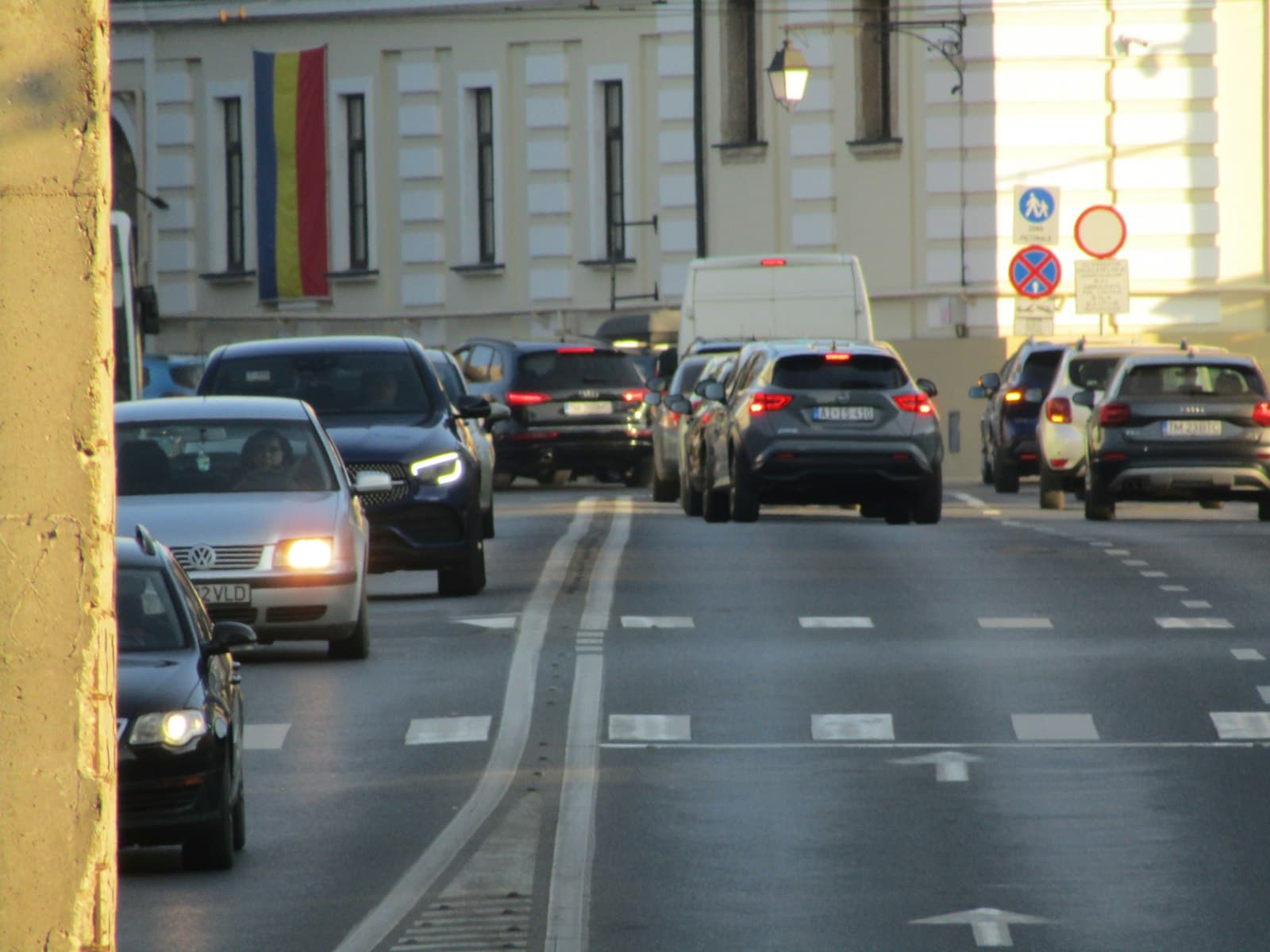 Timișoara — A street filled with lots of traffic next to tall buildings