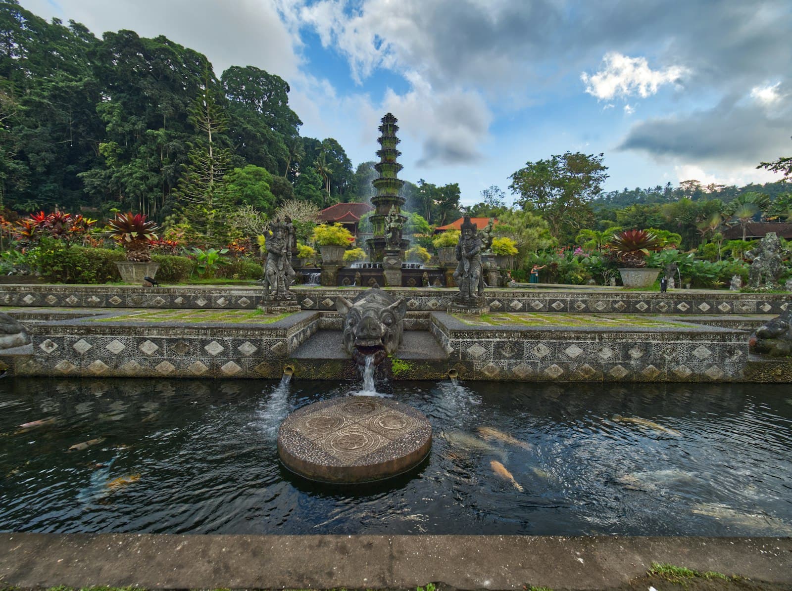 Tirta Gangga — a pond with a fountain surrounded by fish