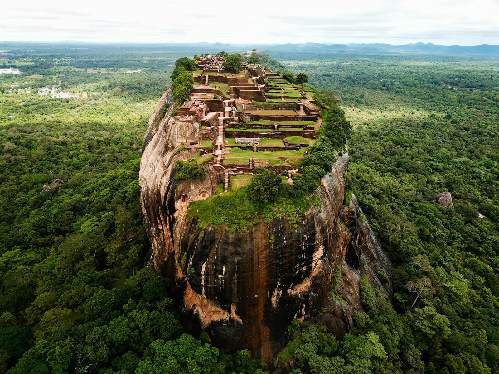 Tissamaharama — brown rock formation on green grass field during daytime