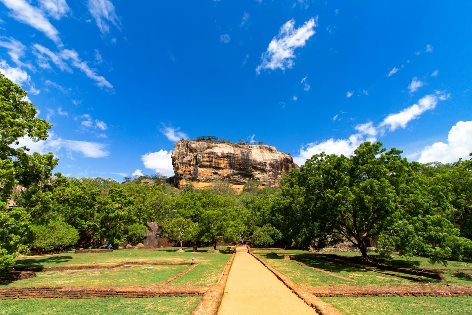 Tissamaharama — green trees and brown dirt road