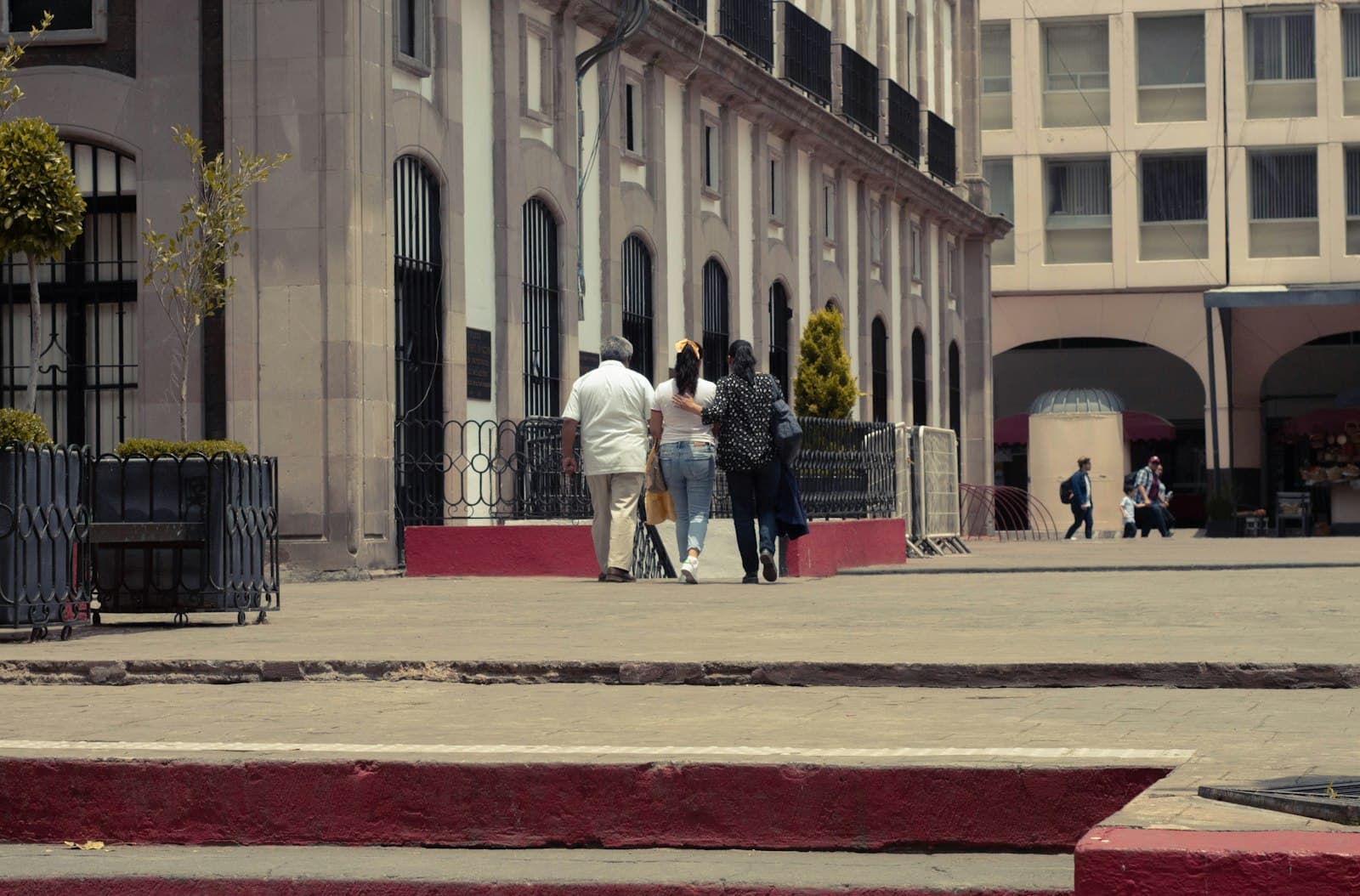 Toluca — a group of people walking on a sidewalk