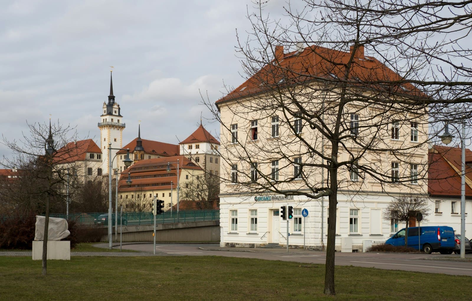 Torgau — white and brown concrete building near bare trees during daytime