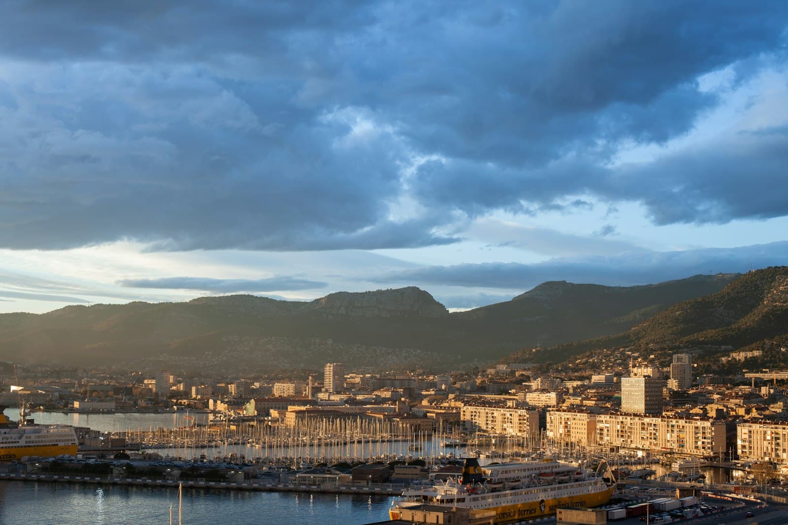 Toulon — city buildings near body of water under cloudy sky during daytime