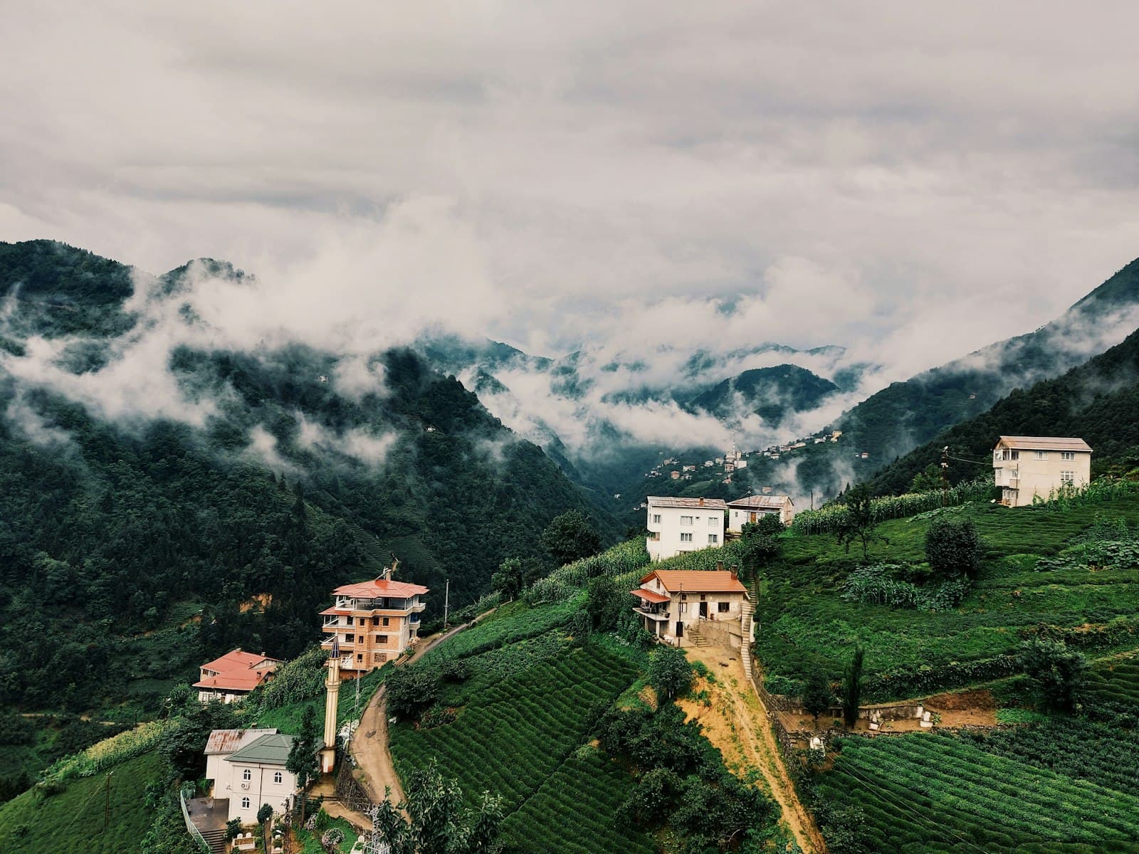 Trabzon — white and brown concrete building on green grass field under white clouds during daytime