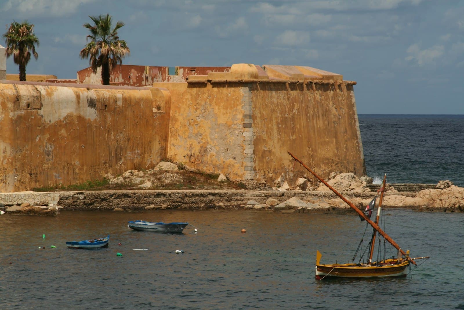 Trapani — brown boat on sea near brown concrete building during daytime