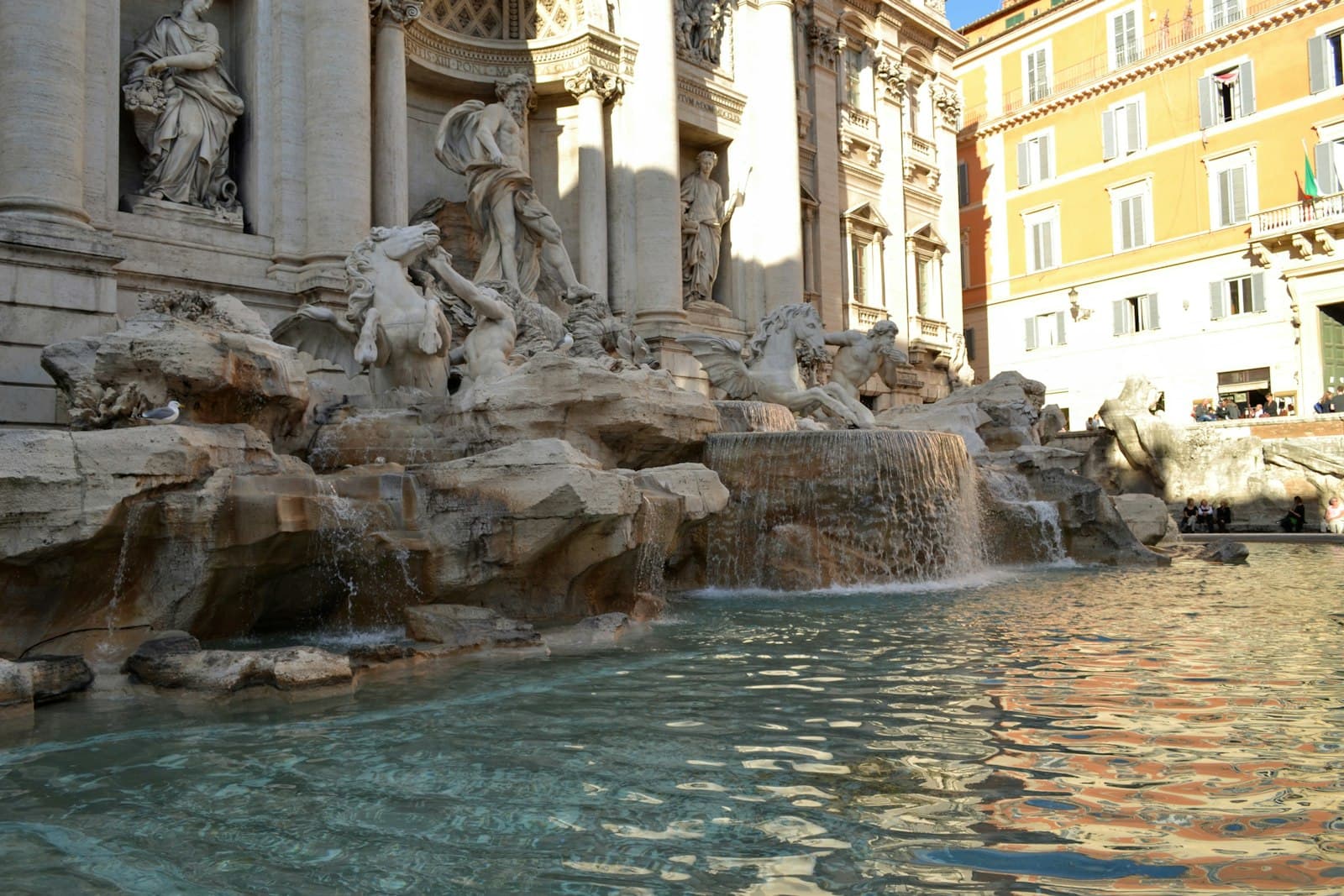 Trevi — a fountain with statues in front of Trevi Fountain