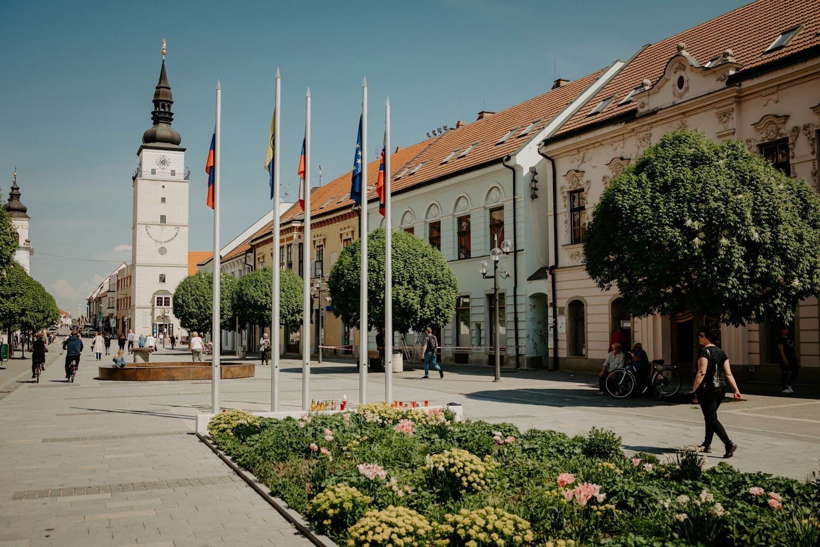 Trnava — a building with flags and people walking around