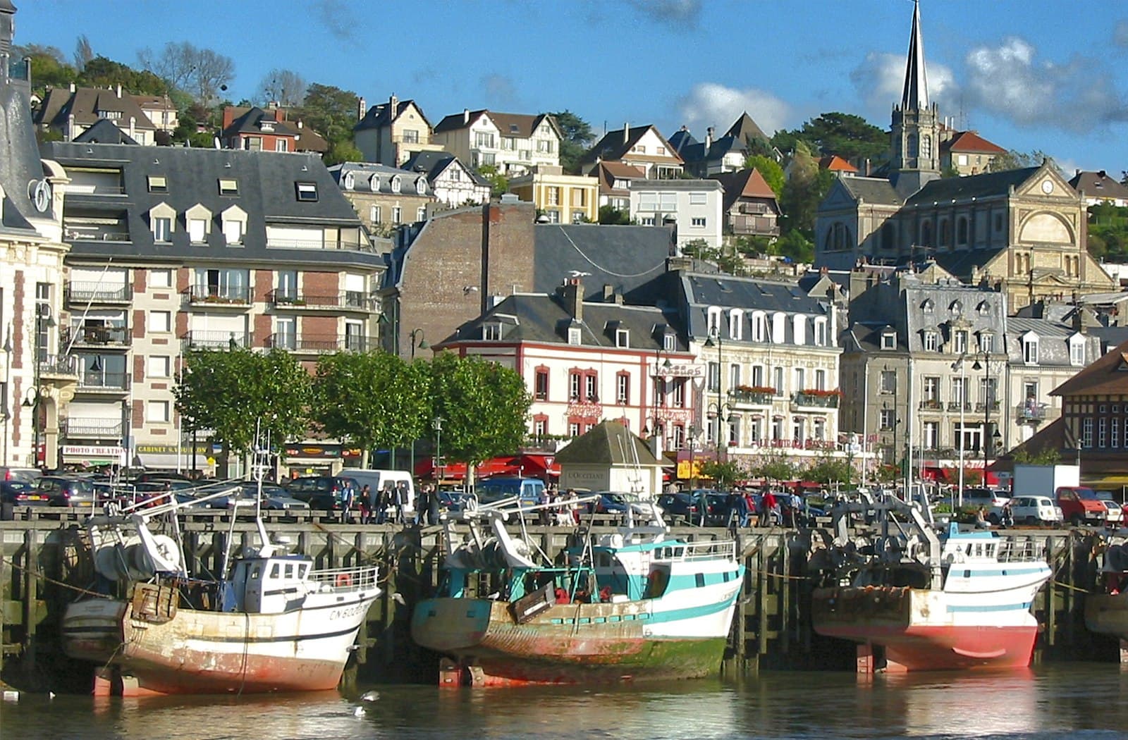 Trouville-sur-Mer — white and red boat on dock near buildings during daytime