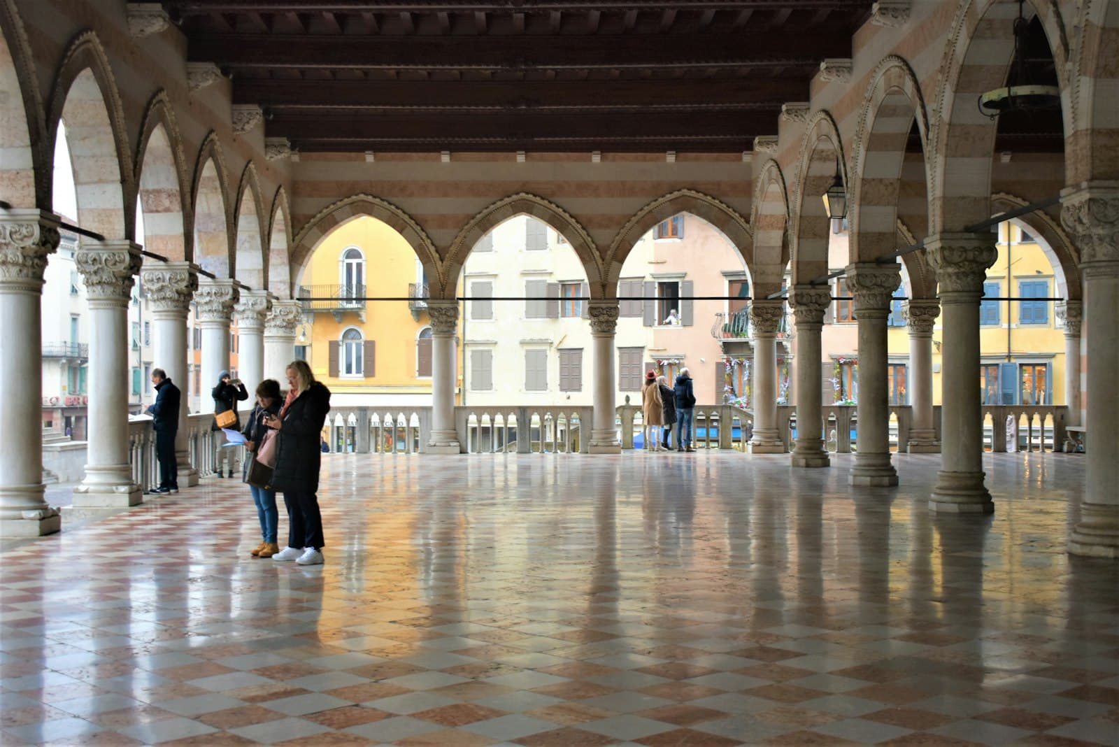 Udine — a couple of people that are standing in a building