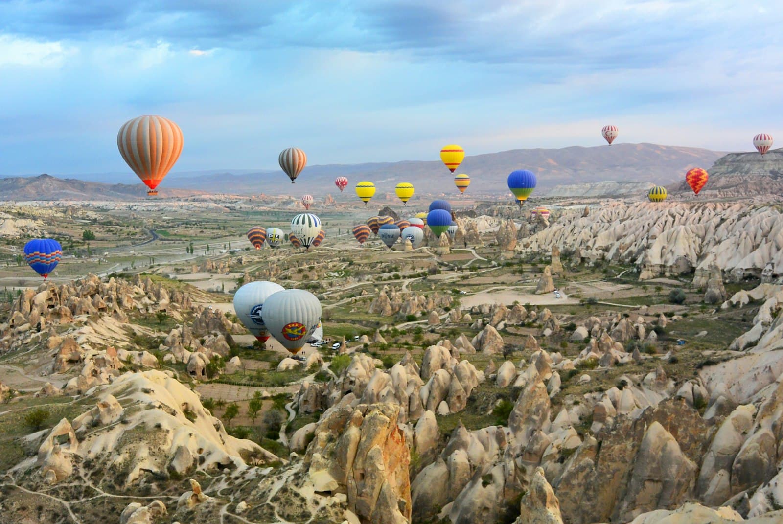 Ürgüp — photo of assorted-color air balloon lot in mid air during daytime