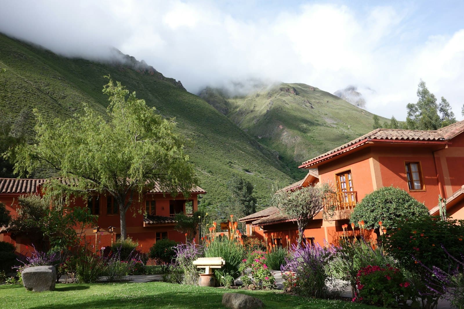 Urubamba — beige houses in foot of green grassy hill