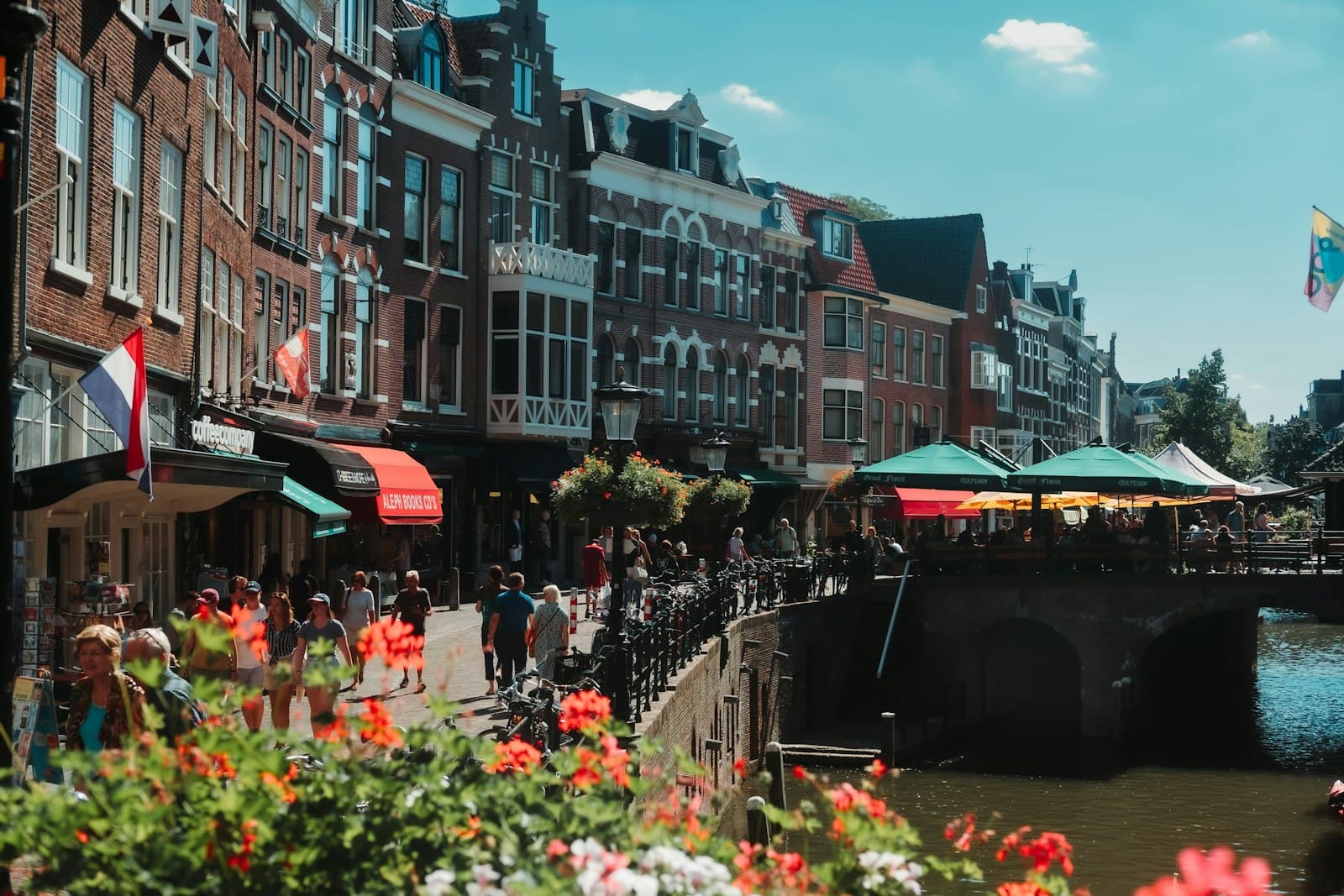 Utrecht — a group of people walking on a bridge over a river