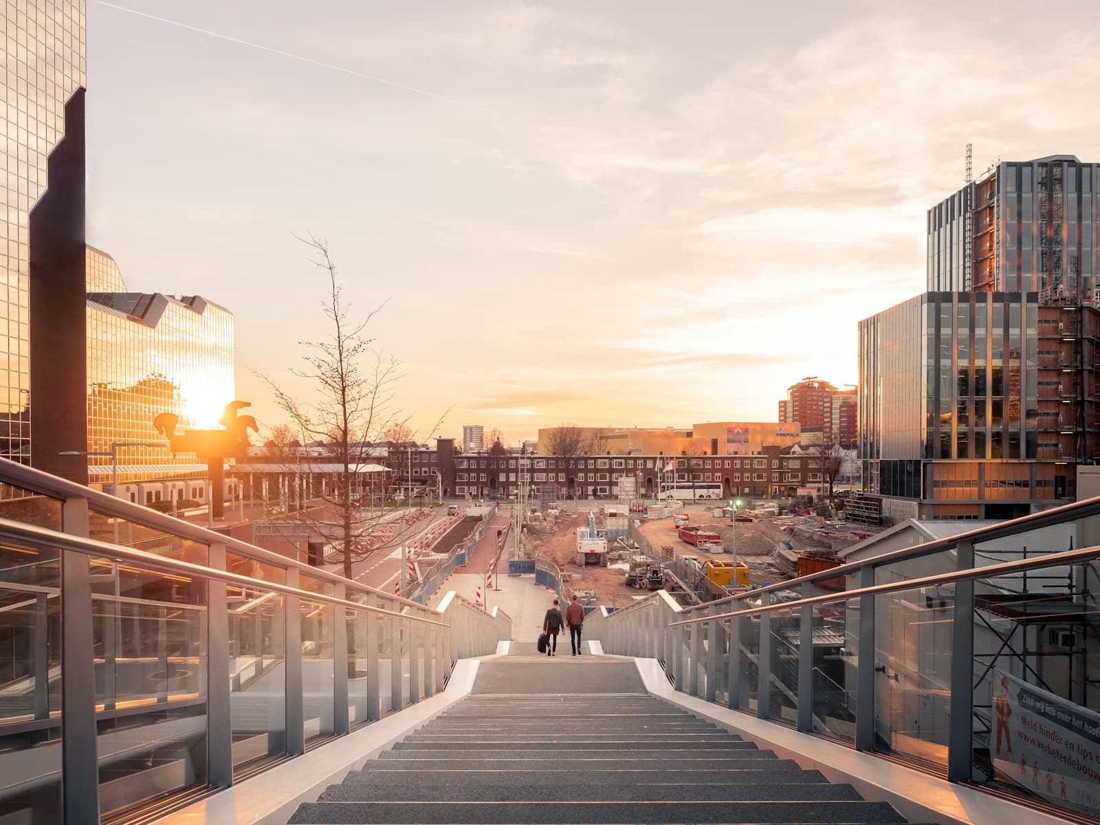 Utrecht — architectural structure photography of two people on stairs near buildings