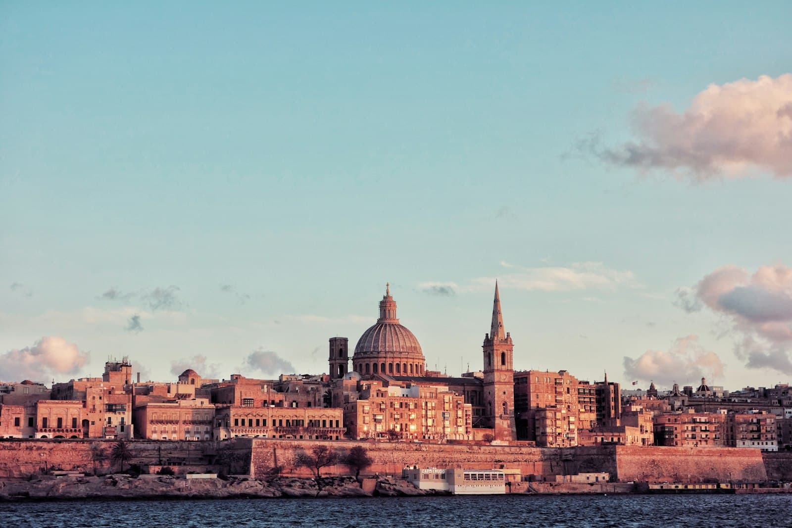 Valletta — brown concrete dome building near body of water