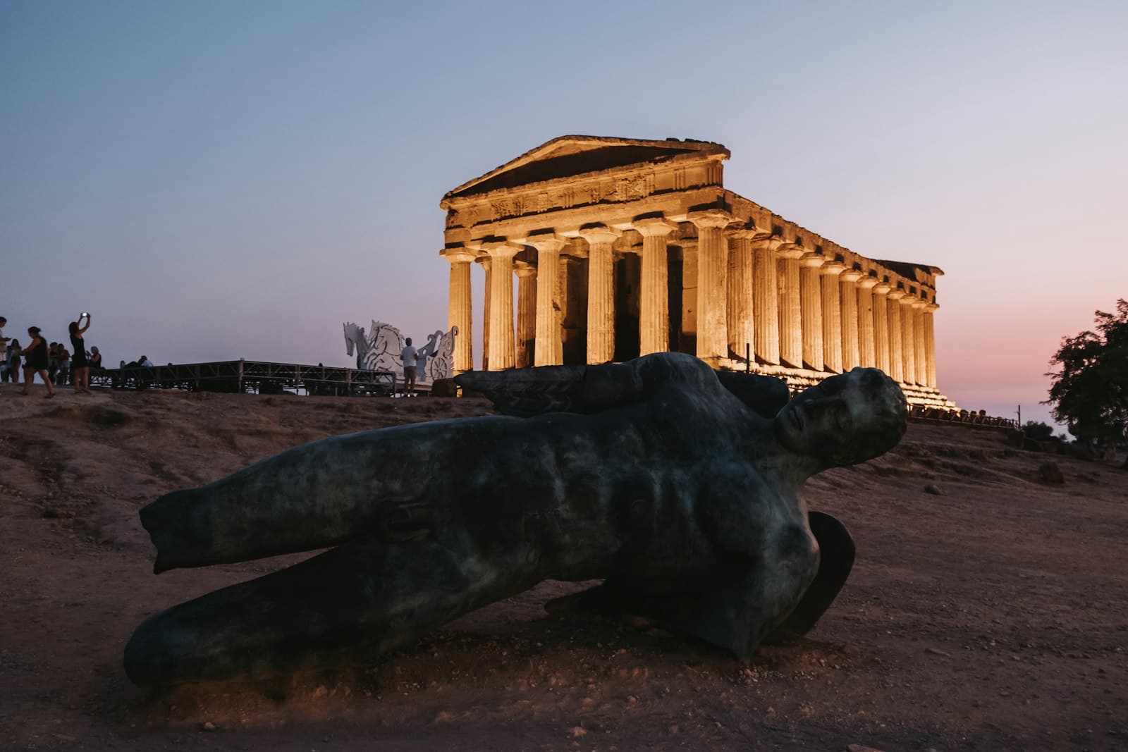 Valley of the Temples — a statue of a bear laying in front of a building