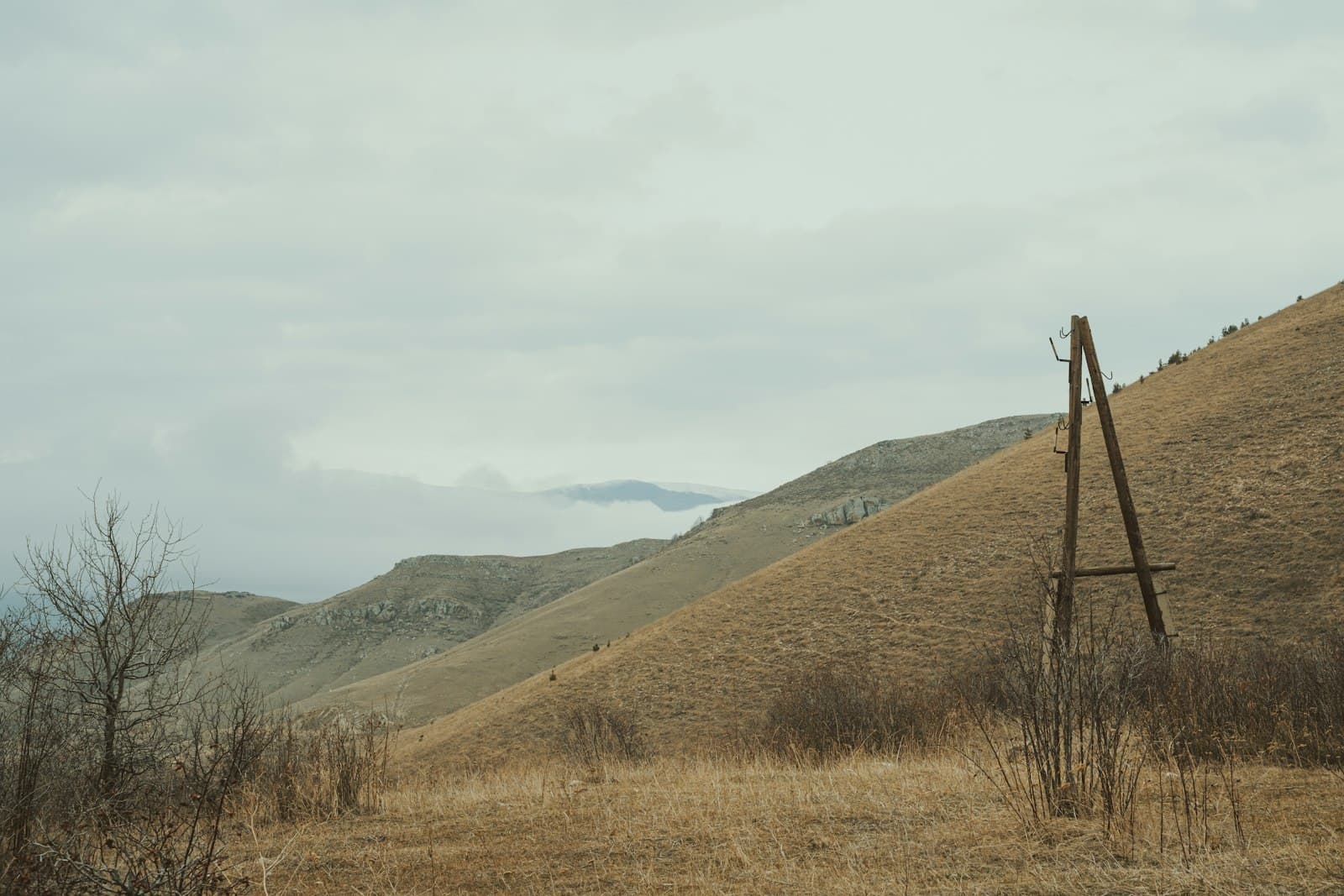 Vanadzor — a wooden structure in a field with mountains in the background
