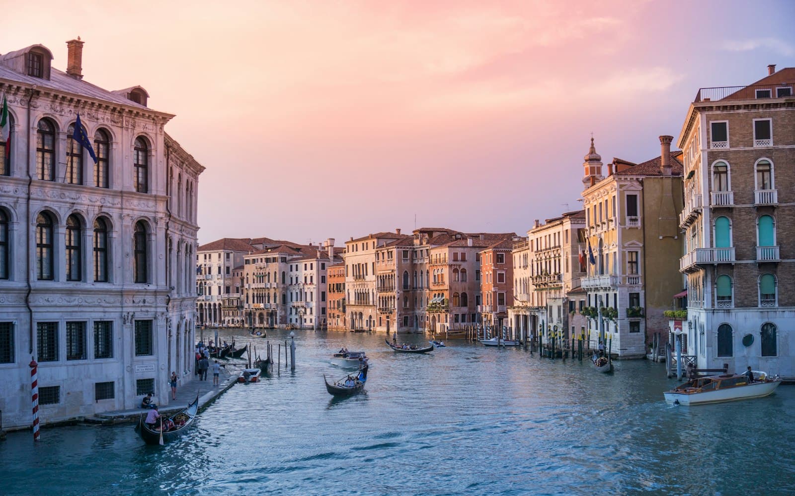 Venice — photo of gondolas on body of water between buildings