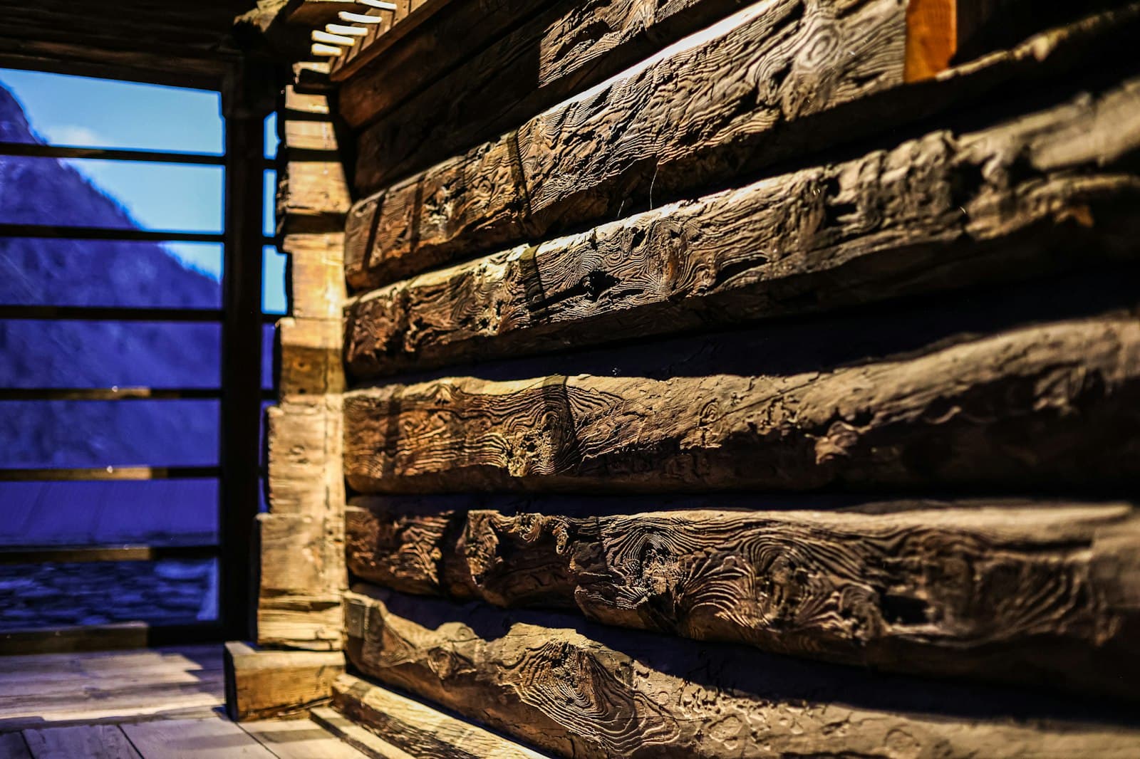 Vercelli — a close up of a wooden structure with a mountain in the background