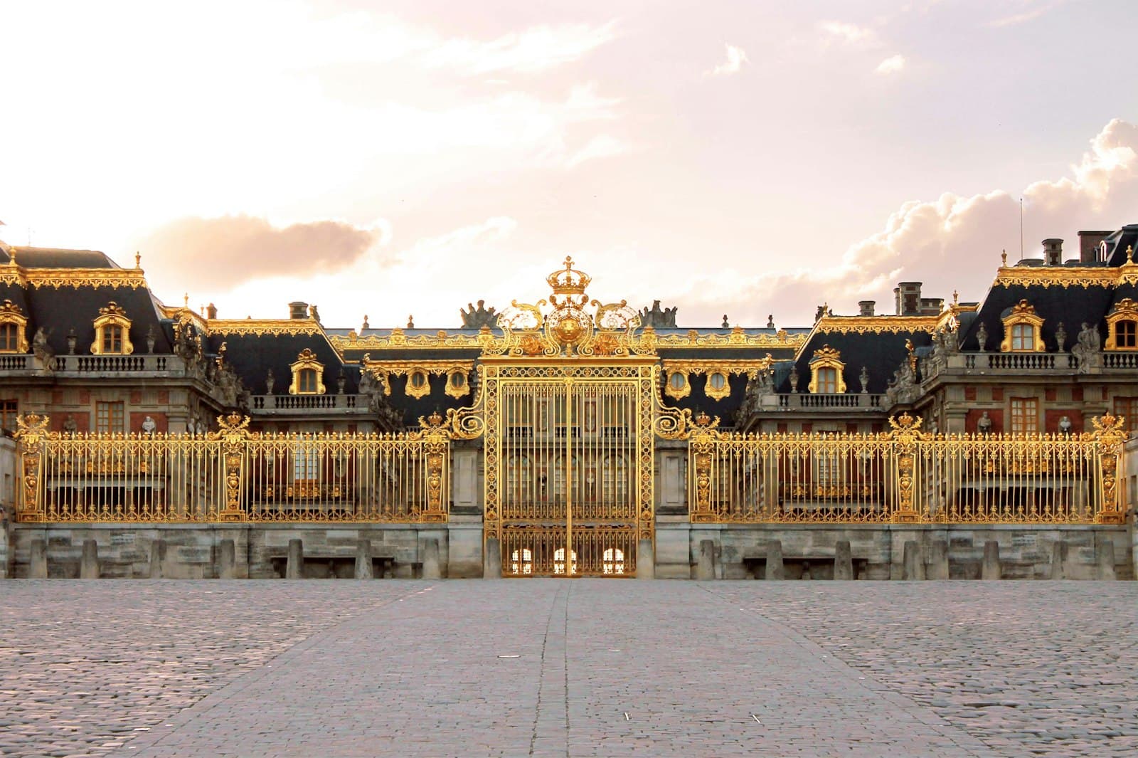 Versailles — a large building with a clock on the front of it