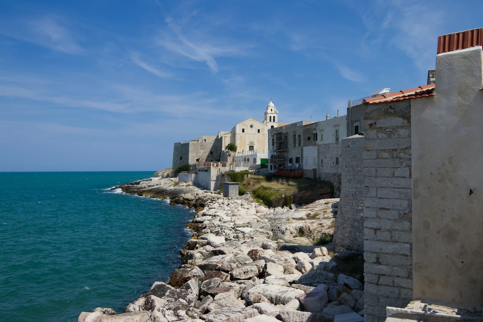 Vieste — a rocky beach with buildings along it