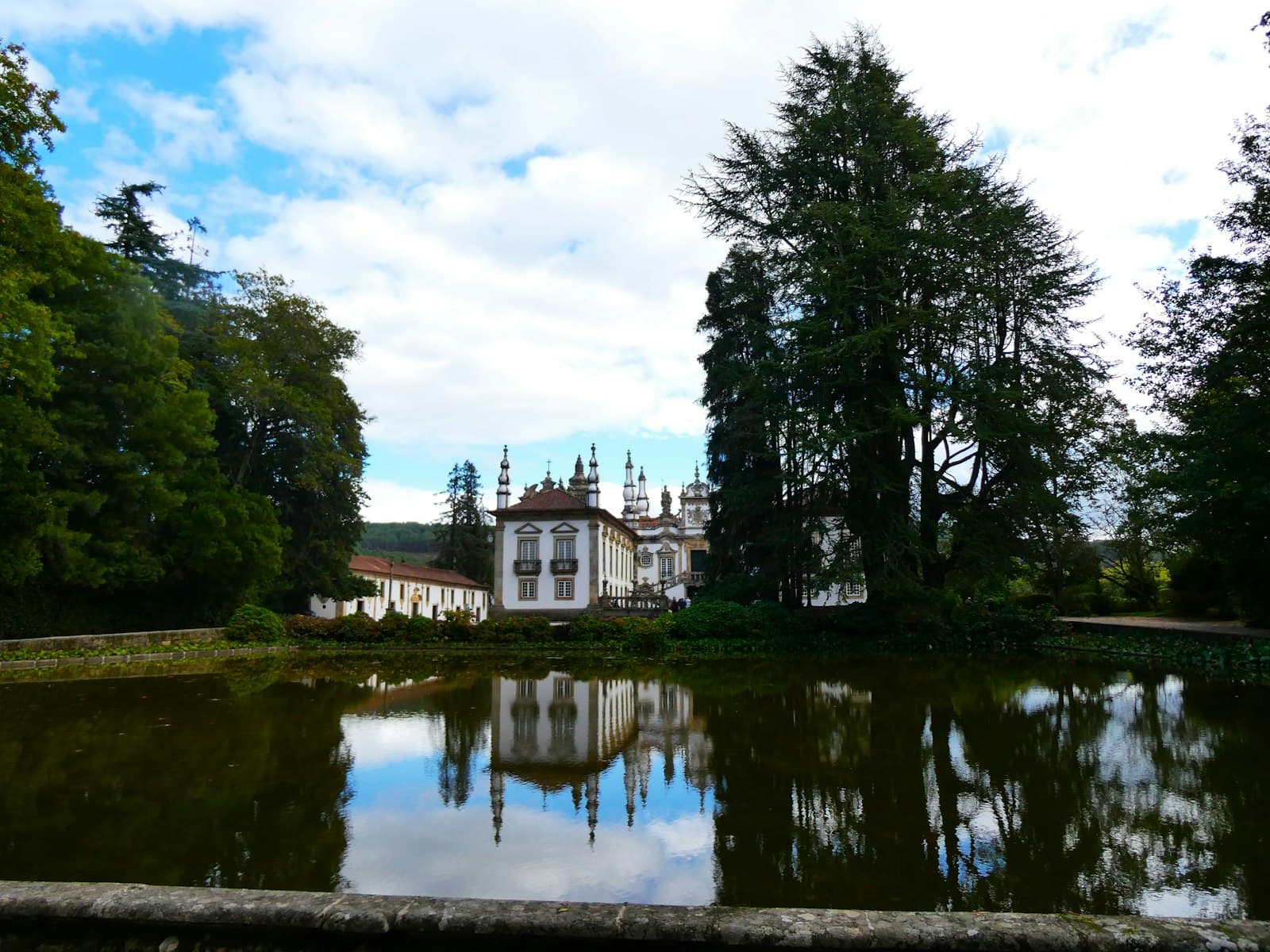 Vila Real — a large white building sitting next to a lake