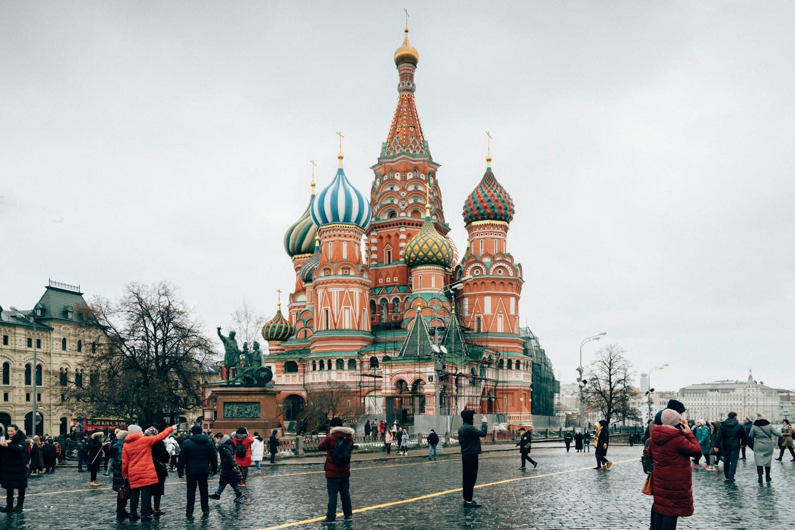 Vladimir — people walking on street near brown and green building during daytime