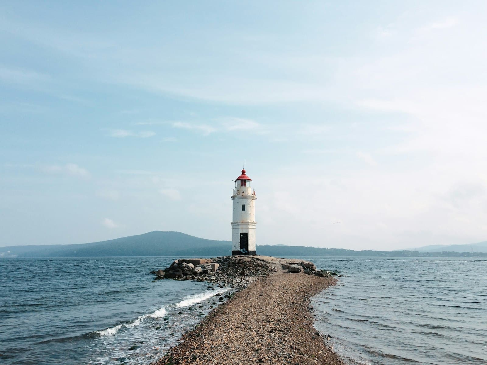 Vladivostok — a light house sitting on top of a rocky shore
