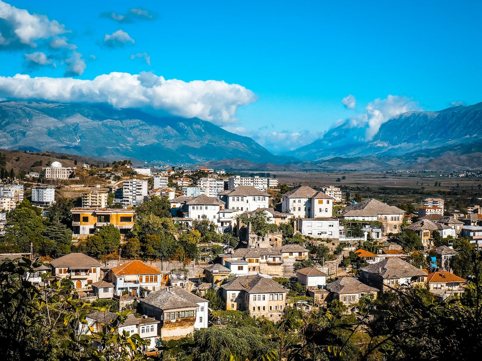Vlorë — a view of a city with mountains in the background