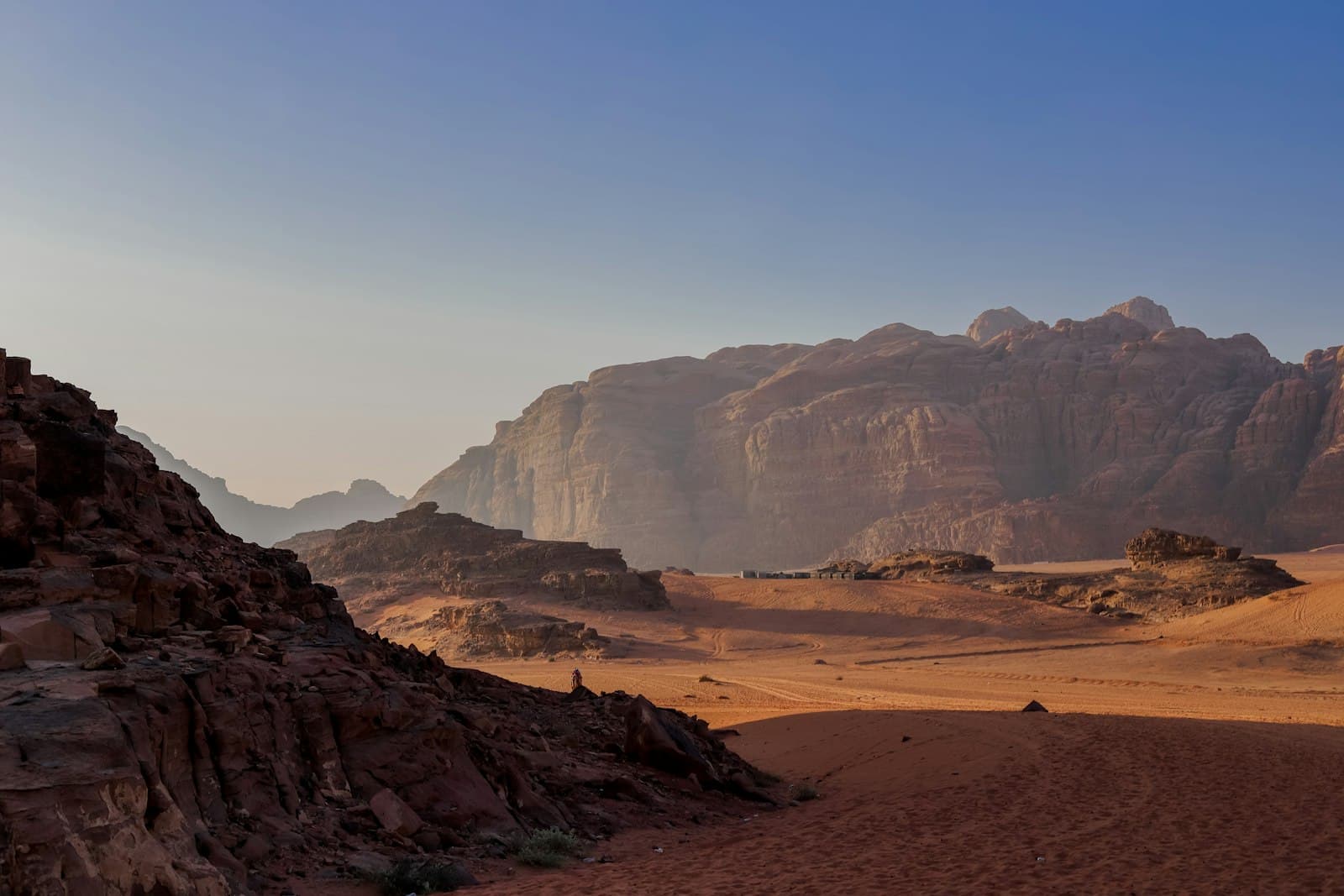 Wadi Rum — a desert with a mountain range in the background