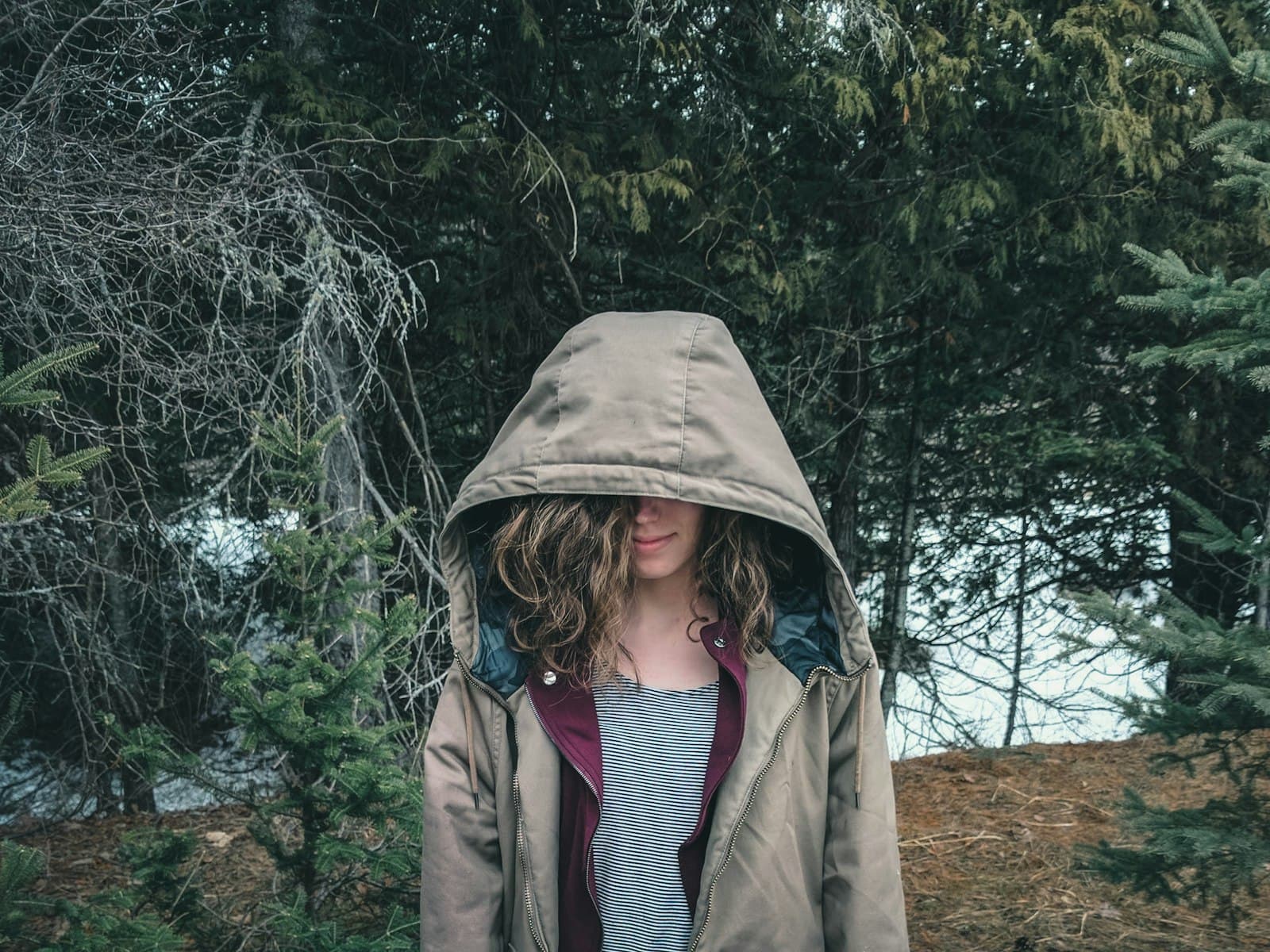 Wakefield — woman in brown coat standing near green trees during daytime